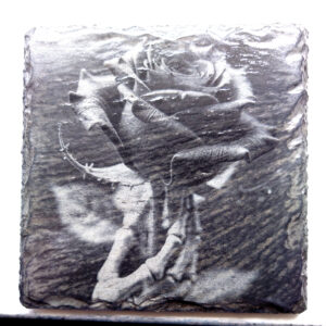 creo pop dot co dot uk A customised laser engraved,. rose held by skeletal hand engraved onto a natural slate coaster image