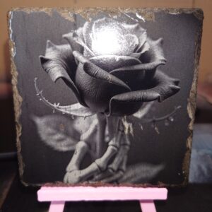 creo pop dot co dot uk A customised laser engraved,. rose held by skeletal hand engraved onto a natural slate coaster image
