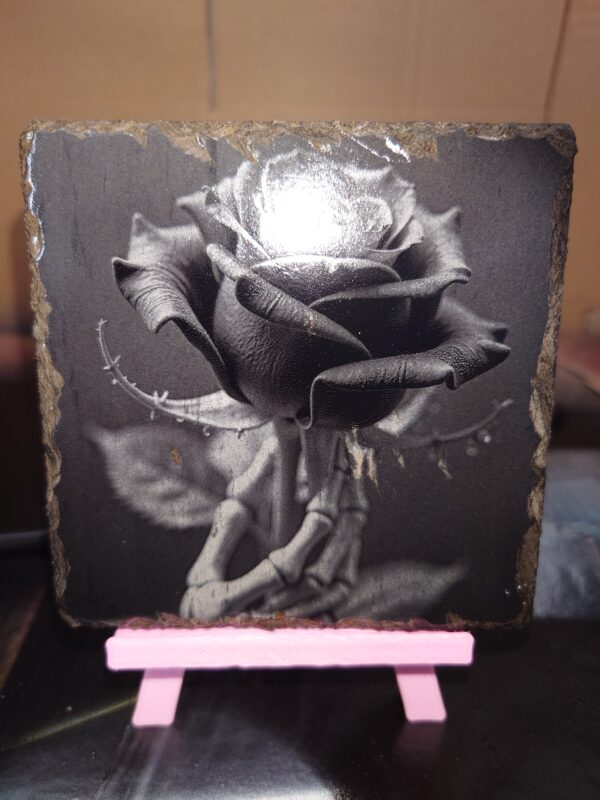 creo pop dot co dot uk A customised laser engraved,. rose held by skeletal hand engraved onto a natural slate coaster image